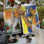 Congress party supporters dance in celebration in the backdrop of posters of party leader Rahul Gandhi, left, and party President Sonia Gandhi, right, outside Sonia's residence in New Delhi, India, Saturday, May 16, 2009. The Congress party headed to a resounding victory Saturday in India's month long national elections, defying expectations of a poor showing to secure a second term in power as the country battles an economic downturn. (AP Photo/Gurinder Osan)